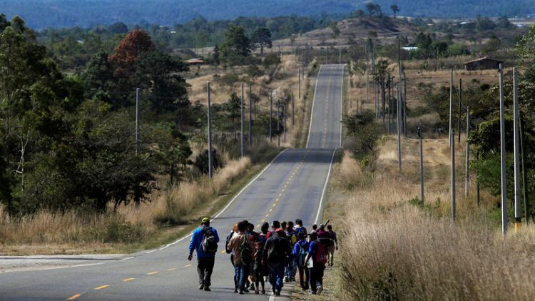 U.S.-bound Honduran migrant caravan grows as Trump argues for wall
