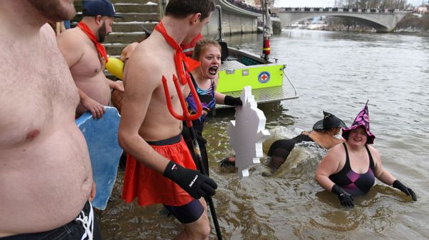 Nearly 2,000 people join annual plunge into icy Danube Nearly 2,000 people join annual plunge into icy Danube