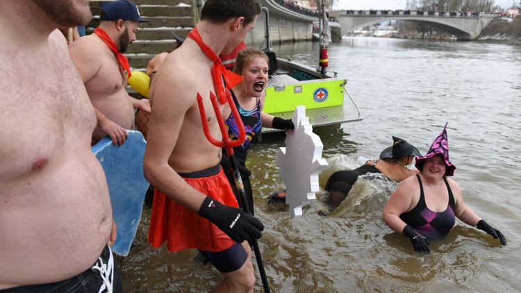 Nearly 2,000 people join annual plunge into icy Danube