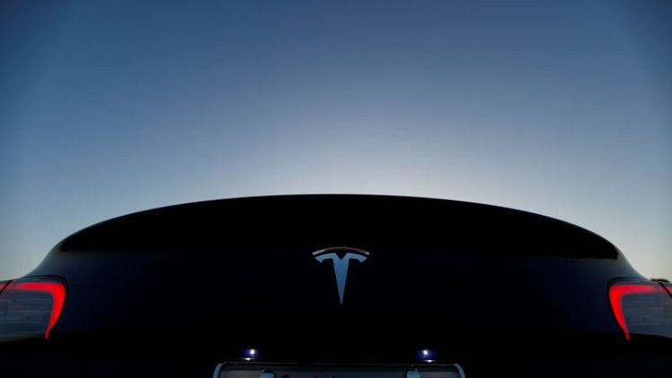 Tesla posts smaller fourth quarter profit than previous quarter