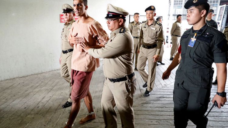 Feet shackled, Bahraini footballer arrives at Thai court to fight extradition