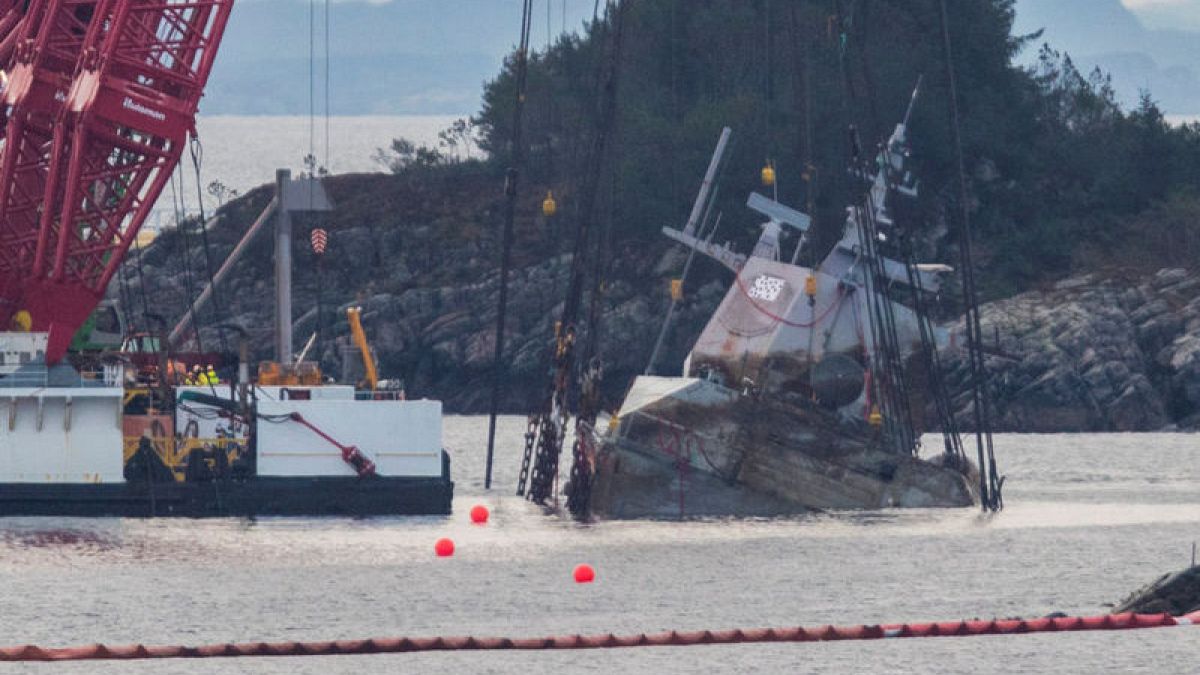 Crane ships begin raising Norwegian navy ship damaged by oil tanker ...