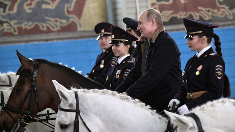 Putin rides horse with female police ahead of International Women's Day