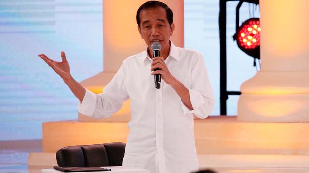 Polls show Indonesian president holds lead ahead of April election Polls show Indonesian president holds lead ahead of April election