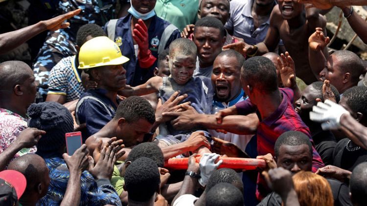 Nigerian boy pulled from rubble remains calm amid chaos