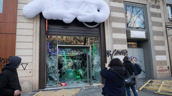 On Paris' Champs Elysees, shattered glass and smoking ruins On Paris' Champs Elysees, shattered glass and smoking ruins