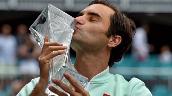 Federer downs injured Isner for 101st career title Federer downs injured Isner for 101st career title