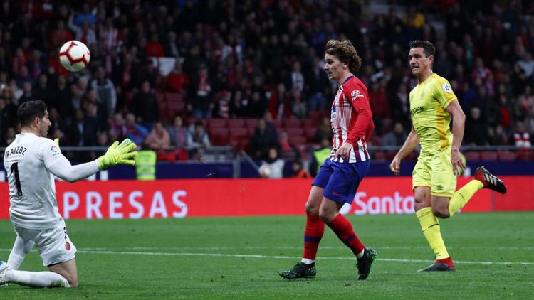 Late strikes from Godin and Griezmann keep Atletico in title chase