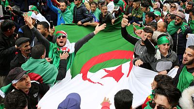 Algerian protesters march again as spy boss reported sacked