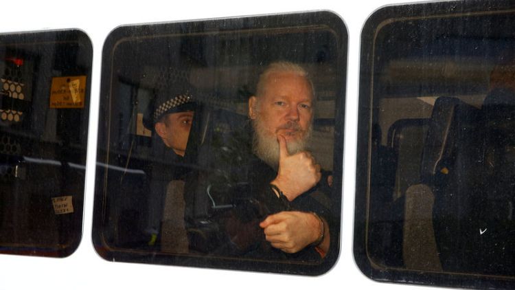 Backstory: A tip-off, a red light - how Reuters captured Assange's thumbs-up