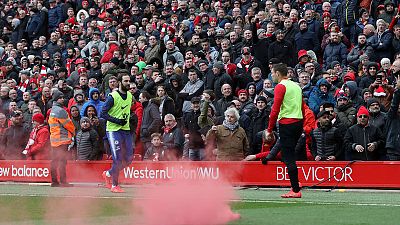 Liverpool vows to ban supporter who threw flare into Chelsea end at Anfield
