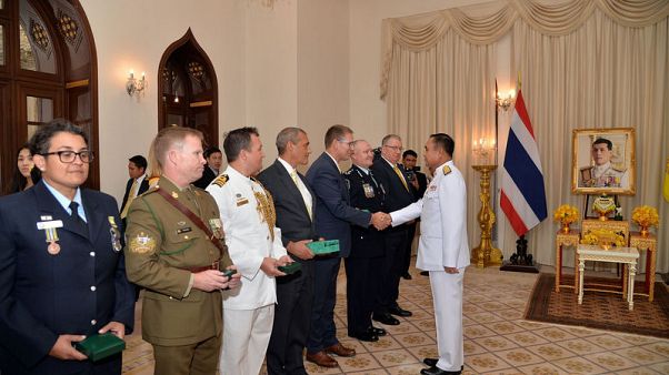 Thai king confers awards on two Australian divers for rescue of cave boys Thai king confers awards on two Australian divers for rescue of cave boys
