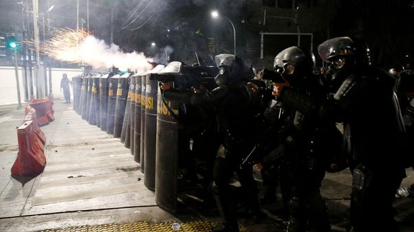 Police fire tear gas to disperse crowds after Indonesia confirms president's re-election Police fire tear gas to disperse crowds after Indonesia confirms president's re-election