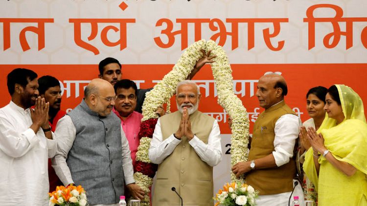 Modi's party promises to boost India's economy; Congress calls exit polls fake