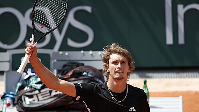 Zverev digs deep to reach French Open round two