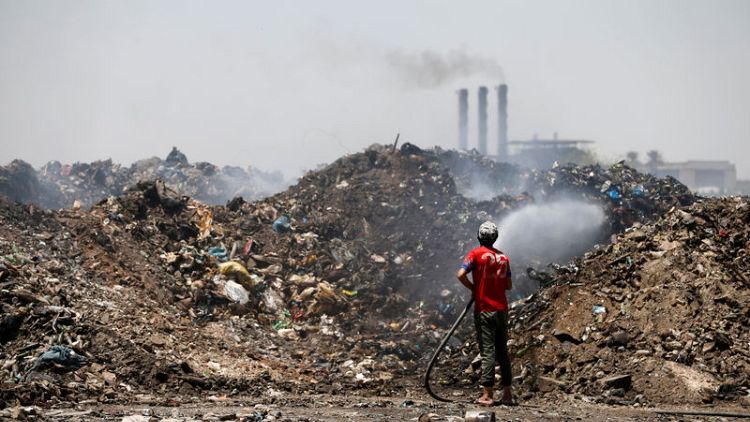 Burning trash and factories belching smoke choke Iraqis