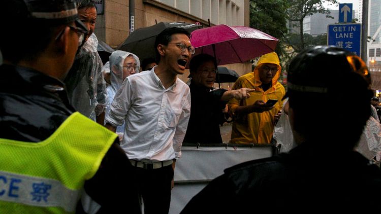 Protesters scuffle with Hong Kong police, government offices shut