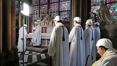 Worshippers in safety hats attend Notre-Dame's first mass since fire Worshippers in safety hats attend Notre-Dame's first mass since fire