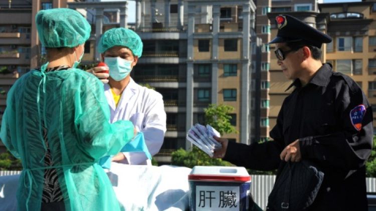 Des membres du mouvemeny spirituel Falun Gong mettent en scène un prélèvement forcé d'organes en Chine pour les vendre, lors d'une manifestation à Taipei, le 20 juillet 2014