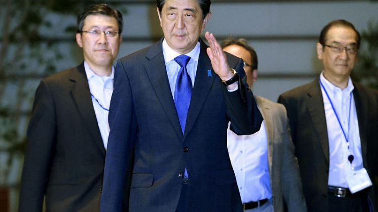 Japan's Abe in hotseat after pension report highlights income-savings gap