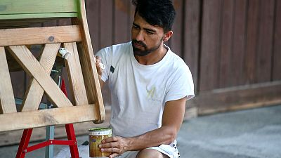 Painting and scraping: An Afghan refugee's hopes for German residence Painting and scraping: An Afghan refugee's hopes for German residence