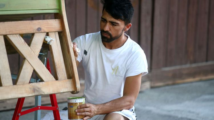 Painting and scraping: An Afghan refugee's hopes for German residence