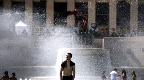 Des jeunes se rafraîchissent dans une fontaine de l'esplanade du Trocadéro à Paris, le 24 juin 2019 Des jeunes se rafraîchissent dans une fontaine de l'esplanade du Trocadéro à Paris, le 24 juin 2019
