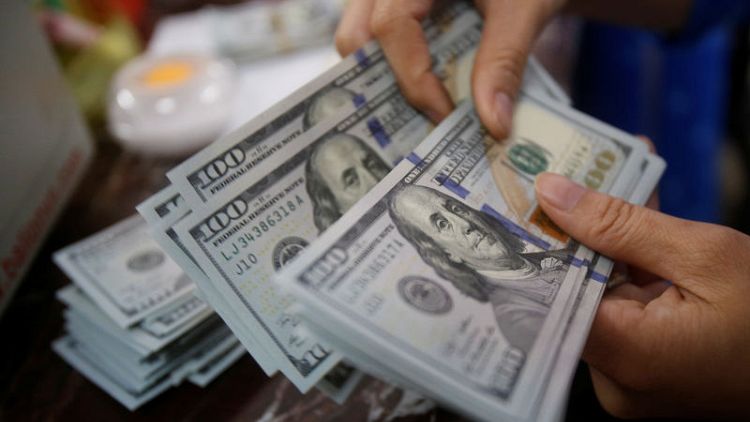 Dollar gains on lower rate cut expectations, stocks flat