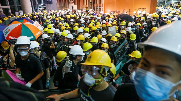 Hong Kong police fire tear gas in running battles after protesters trash legislature