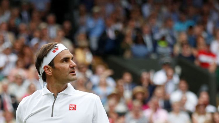 Federer survives first-set wobble to down Wimbledon debutant