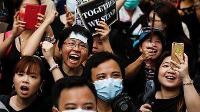 Hong Kong protesters march again, reaching out to Chinese visitors Hong Kong protesters march again, reaching out to Chinese visitors