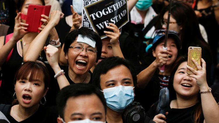 Hong Kong protesters march again, reaching out to Chinese visitors