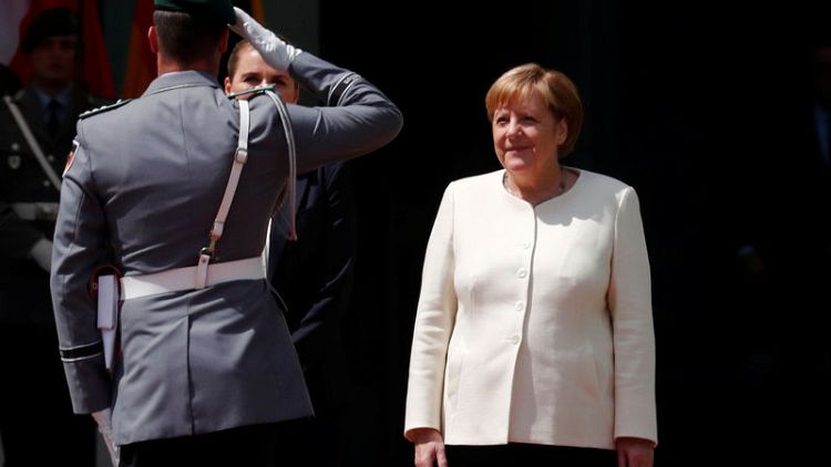 Merkel says German coalition discord over EU top job 'is not easy'