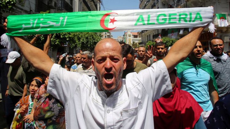 Algerian protesters push for reforms, man tries to burn himself