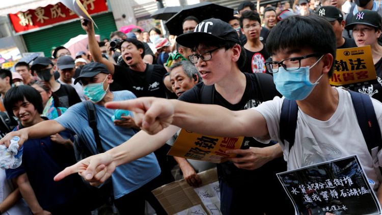 Hong Kong protesters, police clash as demonstrations target Chinese traders