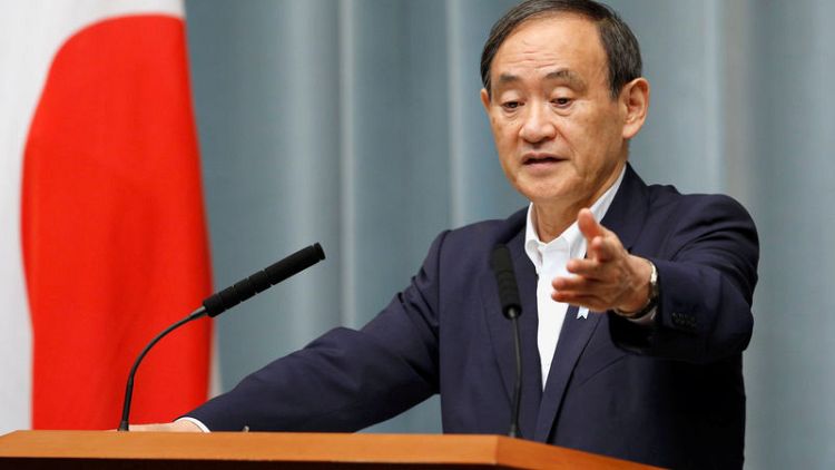 Japan's top government spokesman Suga, finance minister Aso to retain posts - Kyodo