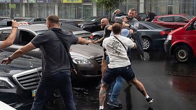 Assailant jumps on ex-Ukraine president's car after he leaves questioning