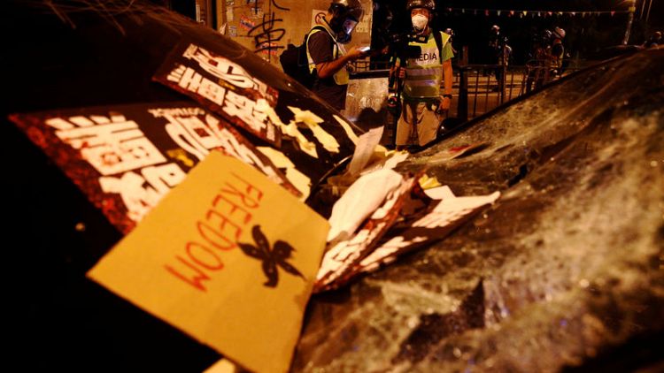 Police fire tear gas, rubber bullets in Hong Kong clash over banned march
