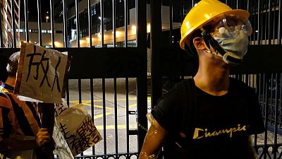 New protest erupts as Hong Kong charges 44 activists with rioting