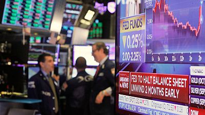 Dollar jumps, stocks fall after Fed rate outlook; pound stalls