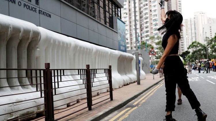 Hong Kong police fire teargas as China says it will not 'sit idly by'
