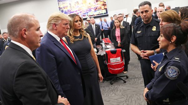 Trump visits mass shooting victims; protesters shout 'Do something!' Trump visits mass shooting victims; protesters shout 'Do something!'