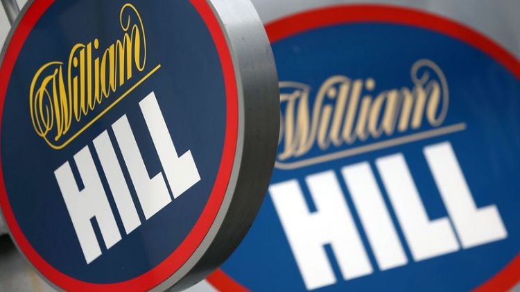 William Hill profit hit by regulatory cap, U.S. expansion costs