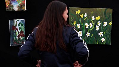Afghan woman finds peace, hope in painting at Hungary migrant camp Afghan woman finds peace, hope in painting at Hungary migrant camp