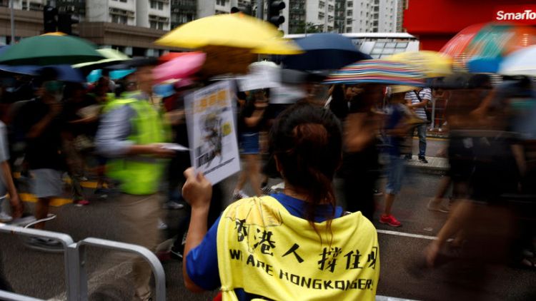 Hong Kongers rally against government under stormy skies