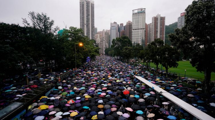 Hong Kong protesters throng streets peacefully in pouring rain