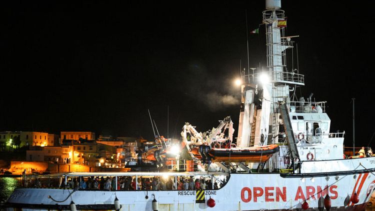 Migrants disembark Open Arms rescue ship on Italian island of Lampedusa