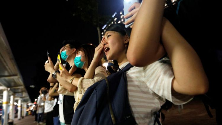 Hong Kong families form peaceful human chains ahead of airport protest