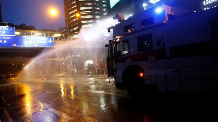 Hong Kong police turn water cannon on protesters, fire tear gas