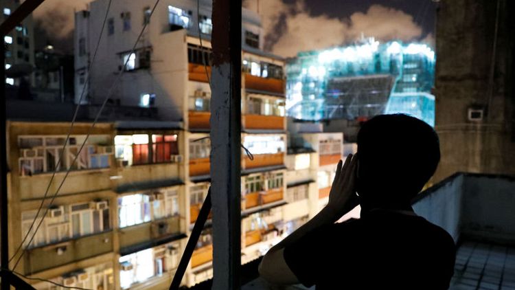 Hong Kong neighbourhoods echo with late night cries for freedom